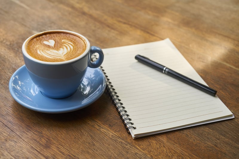 Hands writing on a notebook